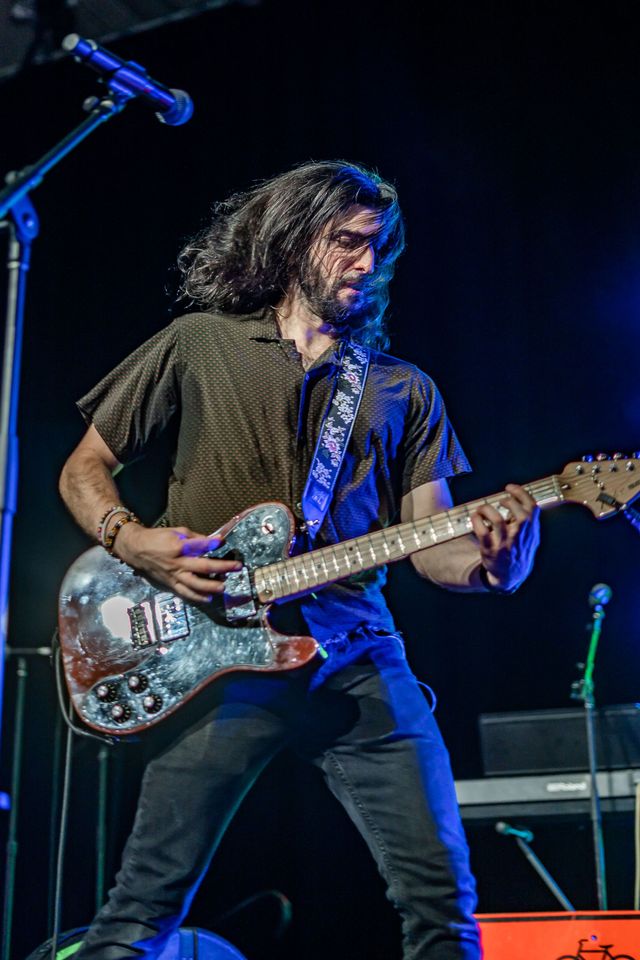 Playing guitar in front of a microphone