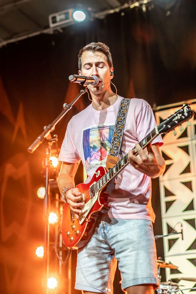 Singing and playing guitar on stage