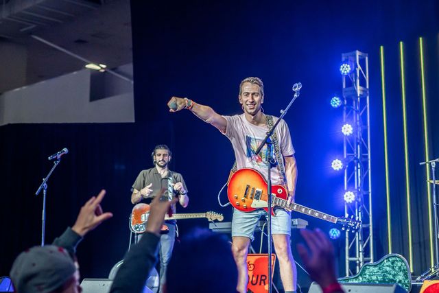Guitarist performing in front of a crowd