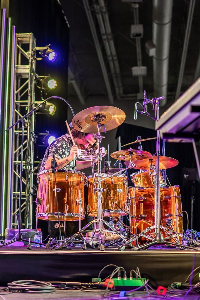 Drummer mid-performance on stage
