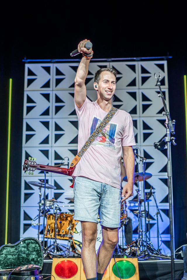 Vocalist holding a microphone on stage